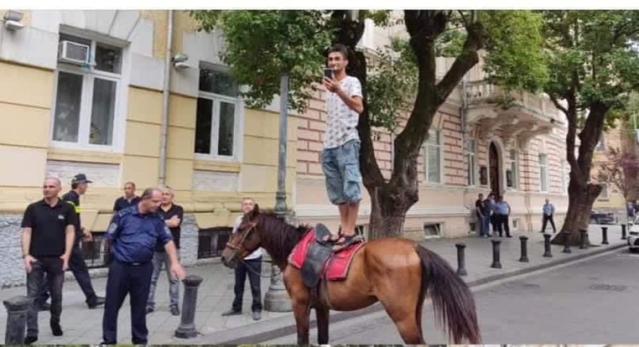 Filming and observing the protest on horseback